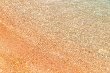 Delightful beach, yellow sand and clear water. Texture, mockup for design, summer background.