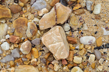 Texture of sand and stones on the beach