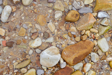Texture of sand and stones on the beach