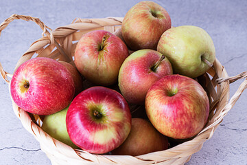 Basket with red apples on a light background