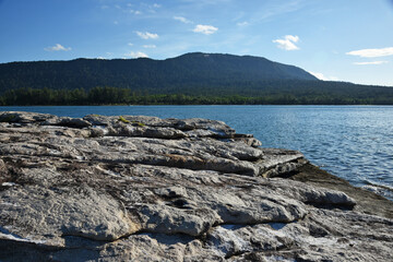 View from the rocky island to the mainland on a sunny day