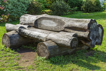 A recreation bench made of wood in a city park in summer sunny day