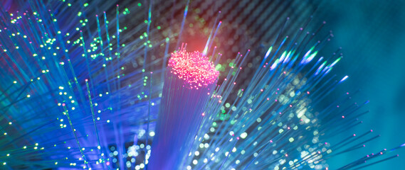 Fiber optics network cable on technology background