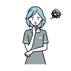 立って手をあごにあてて困っているエステ店員の女性