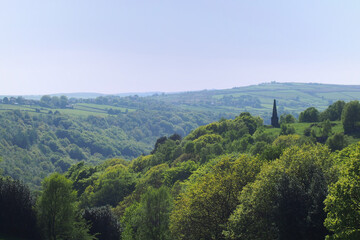 Fototapeta na wymiar view of the valley and woodland looking over hardcastle crags with war memorial in calderdale west yorkshire