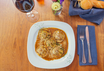 Top view of Italian ravioli on white plate. Gourmet Mediterranean food concept