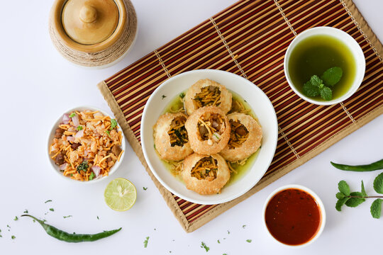Girl women taking spicy Pani puri golgappe with hand, Chat item, India. North Indian street food  Indian panipuri snack eaten tangy tamarind water, potato stuffing Delhi, Mumbai, Holi Diwali Dussehra