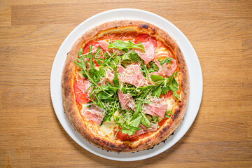 pizza with ham and rocket salad
