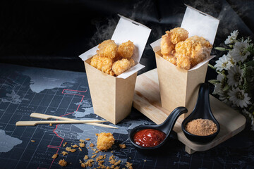 Chicken pop, hot, smoky, with a black background as a snack.