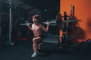 Fototapeta na wymiar Man doing lunge in the gym
