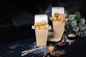 Chicken pop, hot, smoky, with a black background as a snack.