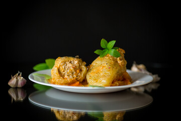 stewed peppers in gravy stuffed with meat and rice in a plate