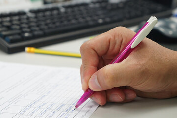 hand with pen and pencil