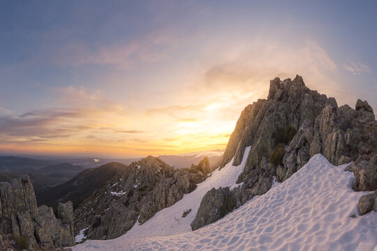 Landscape of snowy mountains at sunset