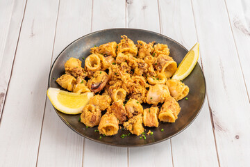 Chopped squid breaded with flour and egg and fried in olive oil with lemon to season