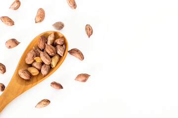 Roasted peanuts in a wooden spoon.