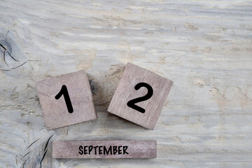 cube calendar for september on wooden background with copy space - obrazy, fototapety, plakaty