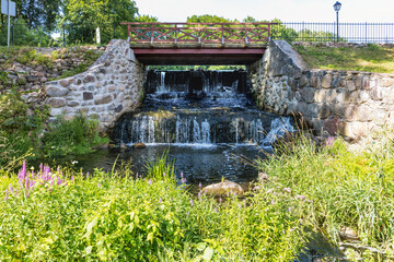 Water mill dam waterfall with bridge