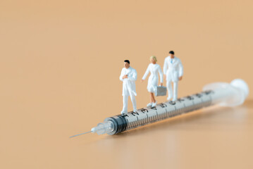 Miniature people Doctor and Nurse emergency medical team walking on syringe with copy space using for digital health retreat take care for covid-19 Coronavirus Immunization vaccinated Hospitality Ads