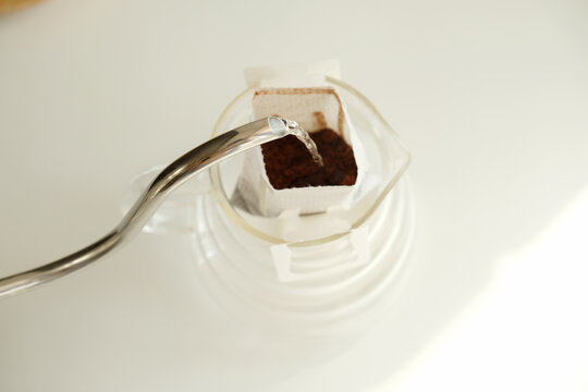 Drip bag coffee brewing process top view. Easy simple brew method, new trend
