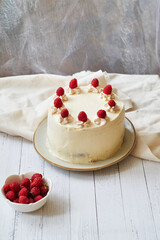 Chocolate raspberry cake with raspberry cheesecake layer. Decorated with berries. Side view