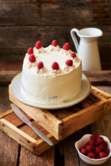 Chocolate raspberry cake with raspberry cheesecake layer. Decorated with berries. Side view