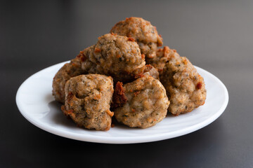 Chicken kofta meatballs mixed with ingredients of onions, garlic fresh herbs and spices mixture on black background