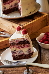 Chocolate raspberry cake with raspberry cheesecake layer. Decorated with berries. Side view
