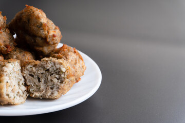 Chicken kofta meatballs mixed with ingredients of onions, garlic fresh herbs and spices mixture on black background