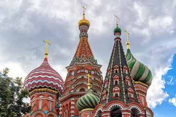Fototapeta na wymiar Decorative domes of St. Basil's Cathedral with golden crosses