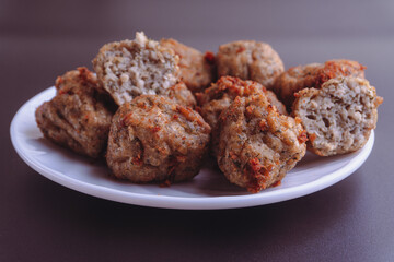Chicken kofta meatballs mixed with ingredients of onions, garlic fresh herbs and spices mixture on black background
