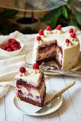 Chocolate raspberry cake with raspberry cheesecake layer. Decorated with berries. Side view