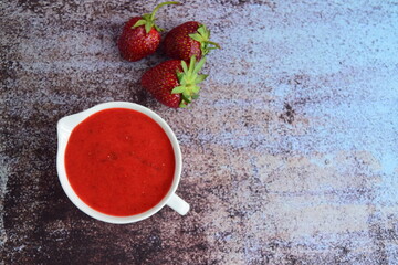 Homemade strawberry dressing in a jug. Flat lay, negative space