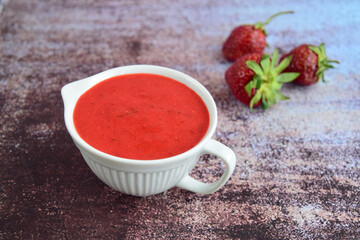 Homemade strawberry dressing in a jug. Selective focus