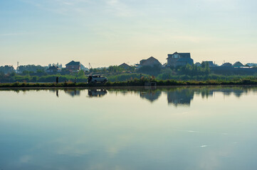 Naklejka premium Sunrise over the lake and fishermen