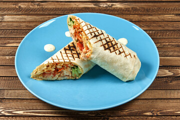 classic Turkish shawarma in a plate on a wooden background. High quality photo