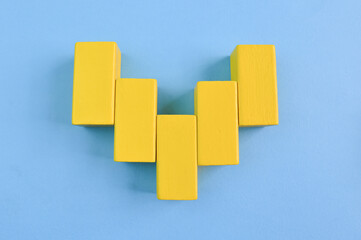 Yellow wooden cube blocks isolated on a yellow background