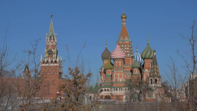 orthodox Saint Basil cathedral with colored domes and Kremlin, winter in Moscow