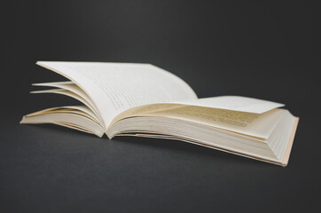 Open book on black background.