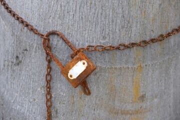 Fototapeta na wymiar Old rusty key and iron chain lock the tree.
