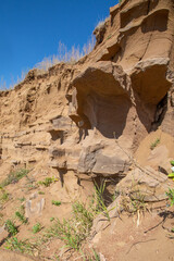 steep ravine slope, sandstone polished by wind and water erosion, stone texture