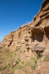 steep ravine slope, sandstone polished by wind and water erosion, stone texture