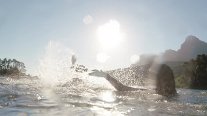 happy friends swimming in lake at sunset having fun splashing in water celebrating summer enjoying freedom having afternoon swim together 