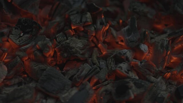 Close-up of glowing red coals in slow motion