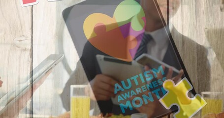 Animation of colourful puzzle pieces and autism text over business people using digital devices - Powered by Adobe