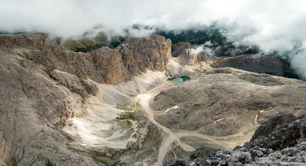 Dolomites, Italy - Rosengarten Group, panorama of the peaks and the Antermoia Lake at the bottom of the valley 