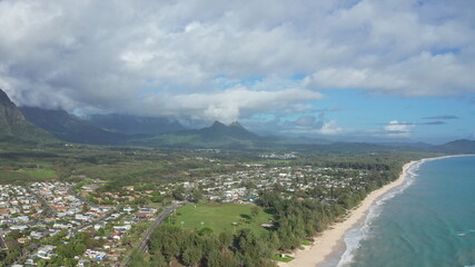 Colorful aerial view of rocky mountains. A tropical beach with turquoise blue ocean water and waves...