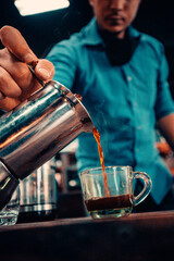 someone serving a cup of coffee