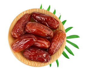 Dates in wooden bowl isolated on white background with clipping path. Top view. Flat lay