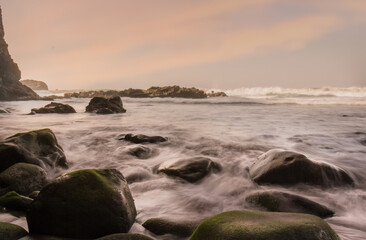 Fototapeta na wymiar long exposure photo of the sea water between the rocks in the evening light